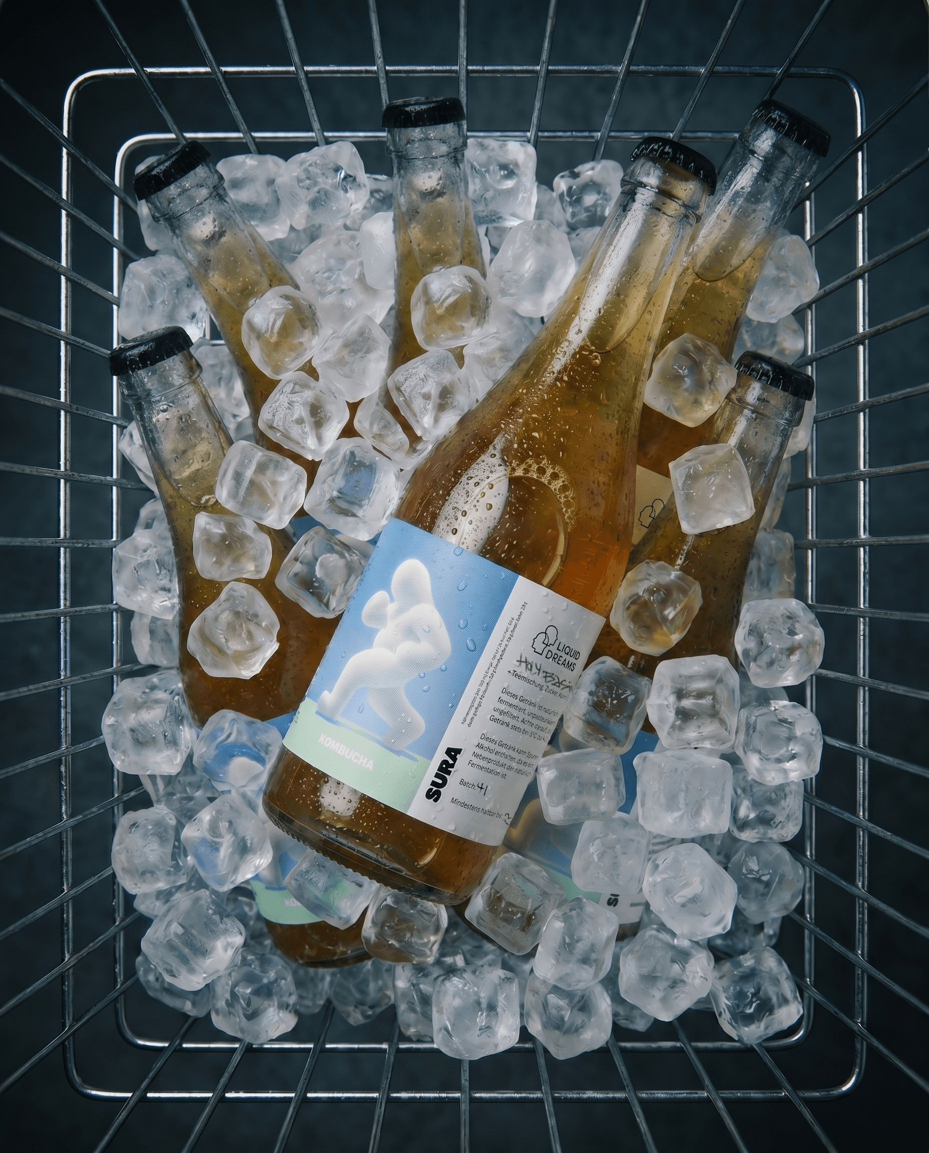 A case of SURA bottles chilling on ice in a wire basket